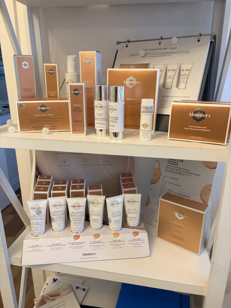 AlumierMD medical‑grade skincare products displayed on the clinic shelf at Blue Bird Aesthetics in Worthing.
