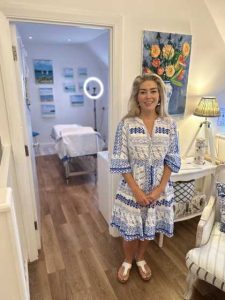 Dr Halliday standing outside the clinic room at Blue Bird Aesthetics